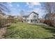 Large backyard with lush lawn, mature trees, and patio space for outdoor entertaining at 5010 Apache Creek Rd, Castle Rock, CO 80109