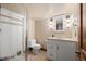 Cozy bathroom with a glass-enclosed shower and a charming vanity with decorative lighting at 5010 Apache Creek Rd, Castle Rock, CO 80109