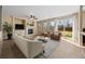 Inviting living room with fireplace, built-ins, and sliding glass doors to the backyard at 5010 Apache Creek Rd, Castle Rock, CO 80109