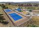 Aerial view showcasing tennis courts and a playground area in a park-like setting within the community at 5010 Apache Creek Rd, Castle Rock, CO 80109