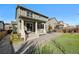 Inviting backyard with a covered patio, artificial turf, and well-maintained fence offering a private outdoor space at 26304 E 4Th Pl, Aurora, CO 80018