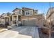 Attractive two-story home with a stone facade, a covered front porch, and an attached two-car garage at 26304 E 4Th Pl, Aurora, CO 80018