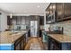 A spacious kitchen featuring stainless steel appliances and granite countertops at 26304 E 4Th Pl, Aurora, CO 80018