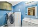 Well-equipped laundry room with washer and dryer next to a sink and vanity at 26304 E 4Th Pl, Aurora, CO 80018