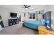 Main bedroom with a tray ceiling, ceiling fan, and carpeted floor at 26304 E 4Th Pl, Aurora, CO 80018