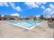 Community pool area with clear blue water, lounge chairs, and umbrellas, perfect for relaxation and recreation at 26304 E 4Th Pl, Aurora, CO 80018