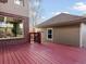 Spacious red stained deck perfect for outdoor entertaining, next to home and detached garage at 8805 E 28Th Ave, Denver, CO 80238