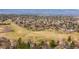Aerial view of a neighborhood with green spaces and walking trails; mountains in the background at 6997 S Poplar Way, Centennial, CO 80112
