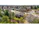 Aerial view of a suburban home featuring mature landscaping, a deck, and a wooded lot at 6997 S Poplar Way, Centennial, CO 80112