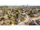 An aerial view showcasing a residential neighborhood with mature trees, manicured lawns, and winding streets at 6997 S Poplar Way, Centennial, CO 80112