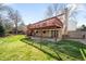 Expansive backyard with a large brick patio, mature trees, and a wooden fence at 6997 S Poplar Way, Centennial, CO 80112