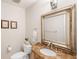 Bathroom with a decorative vanity, marble countertop, and elegant framed mirror at 6997 S Poplar Way, Centennial, CO 80112