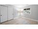 Minimalist bedroom with light flooring, double closet, and bright natural light at 6997 S Poplar Way, Centennial, CO 80112