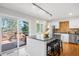 Stylish kitchen with granite island, stainless steel appliances, and access to outdoor deck at 6997 S Poplar Way, Centennial, CO 80112