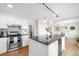 Modern kitchen with stainless steel appliances, granite countertops, and ample cabinet space at 6997 S Poplar Way, Centennial, CO 80112