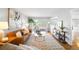 Bright living room with hardwood floors, large windows, and a comfortable seating area at 6997 S Poplar Way, Centennial, CO 80112
