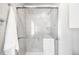 Tiled shower stall with glass doors and chrome fixtures, complemented by safety bars at 6997 S Poplar Way, Centennial, CO 80112