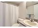 Bathroom featuring shower and toilet with single sink and mirror at 1470 S Quebec Way # 244, Denver, CO 80231