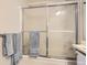 Bathroom featuring a glass shower door and towel rack with stacked towels at 1470 S Quebec Way # 244, Denver, CO 80231