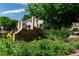 Attractive community sign for Hunt Club 1470 with lush landscaping and building views at 1470 S Quebec Way # 244, Denver, CO 80231