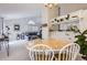 Open-concept dining area with a wood table, leading to a cozy living room with comfortable seating at 1470 S Quebec Way # 244, Denver, CO 80231