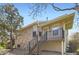 Multi-level exterior elevation with brick, siding, and iron railing detail at 1470 S Quebec Way # 244, Denver, CO 80231