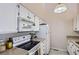Functional kitchen featuring white appliances and cabinets, maximizing space and efficiency at 1470 S Quebec Way # 244, Denver, CO 80231