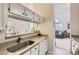 Practical kitchen with white cabinets and a view to the open living area, blending convenience and style at 1470 S Quebec Way # 244, Denver, CO 80231