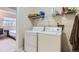 Laundry room with washer and dryer set and a shelf above at 1470 S Quebec Way # 244, Denver, CO 80231