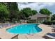 Community pool and clubhouse with ample seating and landscaping at 1470 S Quebec Way # 244, Denver, CO 80231