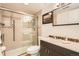 Bathroom featuring tiled shower, glass door, integrated shower head, and vanity at 4832 E Kentucky Ave # E, Denver, CO 80246