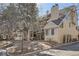 Charming townhouse exterior with multiple levels, wood siding, and mature trees at 4832 E Kentucky Ave # E, Denver, CO 80246