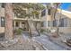 Exterior of the townhouse showing stairway and walkway with stone landscaping at 4832 E Kentucky Ave # E, Denver, CO 80246