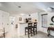 Modern kitchen featuring a breakfast bar, stainless steel appliances and white cabinetry at 4832 E Kentucky Ave # E, Denver, CO 80246