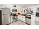 Well-lit kitchen features stainless steel appliances, white cabinets, and modern finishes at 4832 E Kentucky Ave # E, Denver, CO 80246