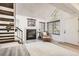 Inviting living room with a fireplace, staircase and natural light from large windows at 4832 E Kentucky Ave # E, Denver, CO 80246