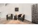 Cozy sitting area with carpeted flooring, two leather chairs, and a side table at 4832 E Kentucky Ave # E, Denver, CO 80246