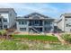 Aerial view of the backyard showcasing a well-maintained lawn, solar panels, and a two-story home at 18212 W 95Th Pl, Arvada, CO 80007