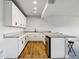 Basement kitchen area offers sleek white cabinetry and modern countertops at 18212 W 95Th Pl, Arvada, CO 80007