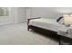 Basement bedroom featuring neutral walls, carpet, a large window, and a comfortable bed with a side table at 18212 W 95Th Pl, Arvada, CO 80007