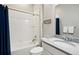 Bright bathroom with a shower-tub combination featuring white tile, a granite vanity, and modern fixtures at 18212 W 95Th Pl, Arvada, CO 80007