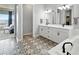 Spacious bathroom with a double sink vanity, patterned tile floors, and a soaking tub at 18212 W 95Th Pl, Arvada, CO 80007