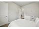 Neutral bedroom offering a serene space with a view of a changing table and an open doorway at 18212 W 95Th Pl, Arvada, CO 80007