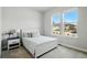 Bright bedroom featuring a double window, natural light, and neutral decor at 18212 W 95Th Pl, Arvada, CO 80007