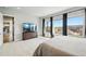 Calm primary bedroom featuring large windows and an elegant dresser at 18212 W 95Th Pl, Arvada, CO 80007