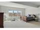 Bedroom boasting three large windows with picturesque outdoor views and a comfortable queen-sized bed at 18212 W 95Th Pl, Arvada, CO 80007