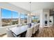 Bright dining room with a large table and expansive windows offering scenic views at 18212 W 95Th Pl, Arvada, CO 80007