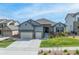 Charming home featuring a well-manicured lawn and a spacious three car garage at 18212 W 95Th Pl, Arvada, CO 80007