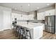 Modern kitchen with stainless steel appliances, white cabinets, and a spacious center island at 18212 W 95Th Pl, Arvada, CO 80007