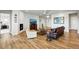 Spacious living room boasts hard wood floors, fireplace, and natural lighting at 18212 W 95Th Pl, Arvada, CO 80007